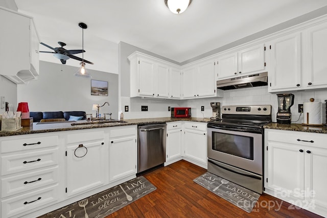 kitchen with ceiling fan, dark stone counters, stainless steel appliances, and tasteful backsplash