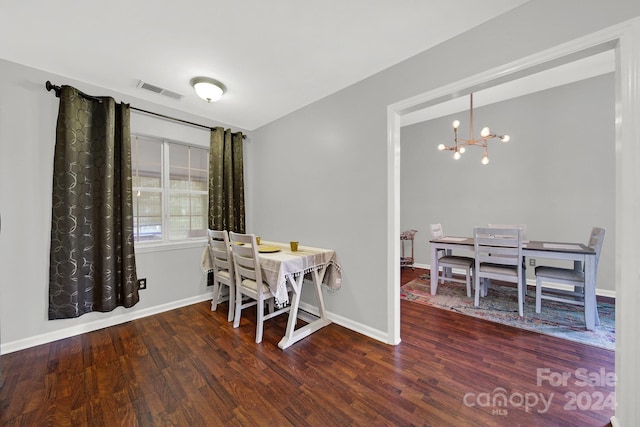 dining area with an inviting chandelier and hardwood / wood-style floors