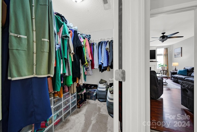 spacious closet with ceiling fan and hardwood / wood-style floors