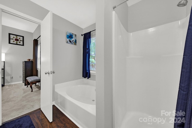 bathroom with plus walk in shower and wood-type flooring