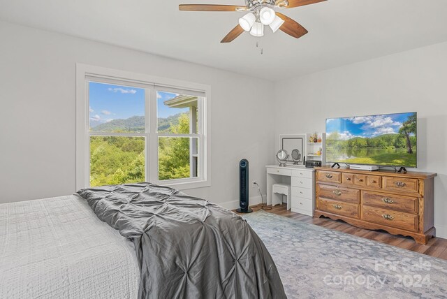 bedroom with ceiling fan and wood-type flooring