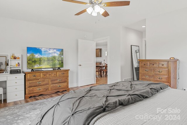 bedroom with ceiling fan and hardwood / wood-style floors