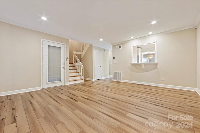 unfurnished living room with light hardwood / wood-style floors and ornamental molding