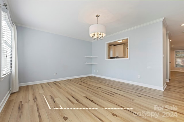 interior space with crown molding, light hardwood / wood-style flooring, and plenty of natural light