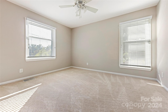 spare room featuring carpet flooring and ceiling fan