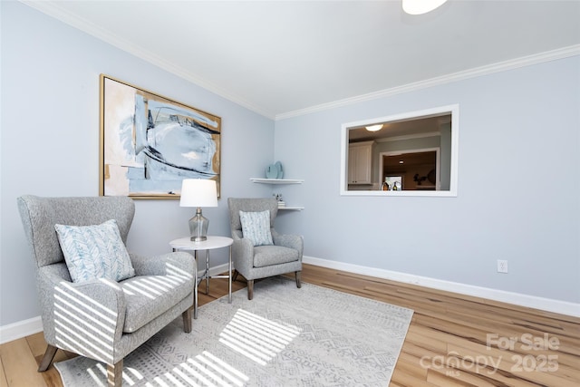 living area featuring ornamental molding, wood finished floors, and baseboards