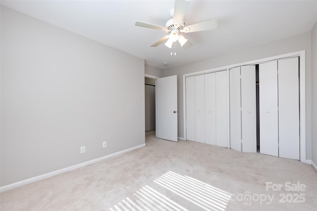 unfurnished bedroom featuring carpet floors, a ceiling fan, baseboards, and a closet