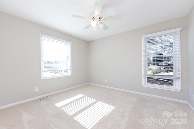 unfurnished room featuring visible vents, baseboards, ceiling fan, and light colored carpet