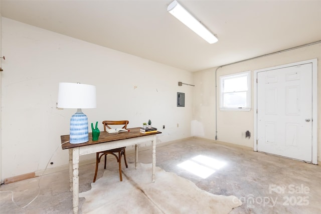 office area featuring electric panel and unfinished concrete floors