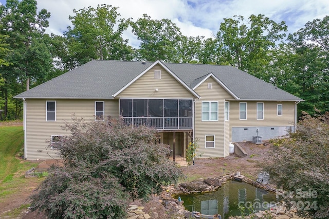 view of front of property with a sunroom and cooling unit