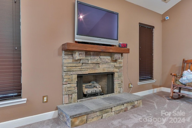 carpeted living room featuring a fireplace