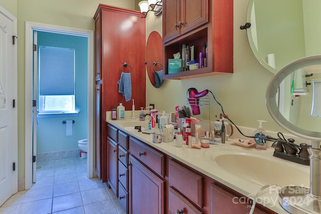 bathroom featuring dual bowl vanity, toilet, and tile patterned flooring