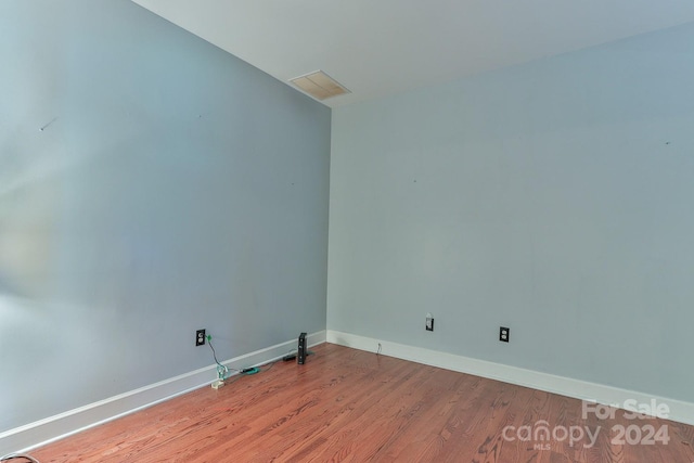 empty room with hardwood / wood-style floors