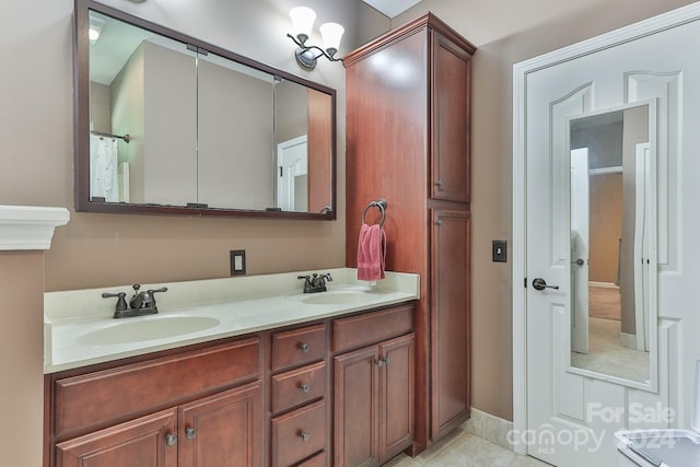 bathroom with dual vanity and tile patterned flooring