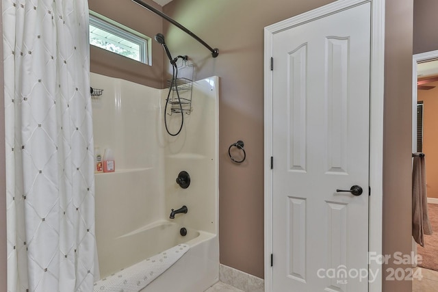 bathroom featuring shower / tub combo with curtain and tile patterned floors