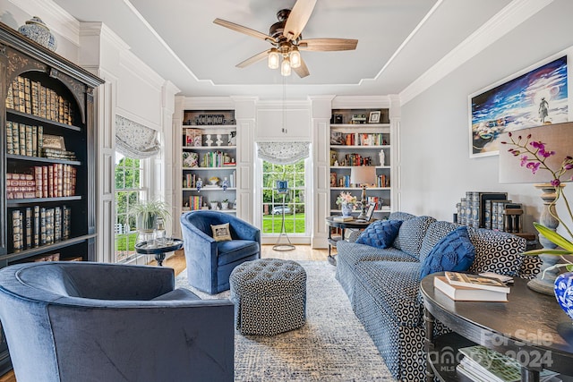 living room with ceiling fan, crown molding, and hardwood / wood-style flooring