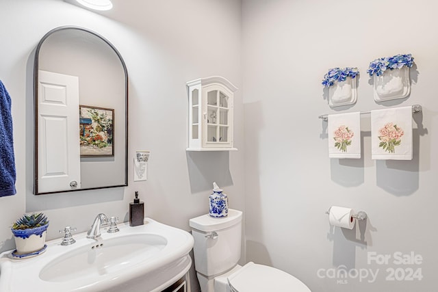 bathroom featuring toilet and vanity