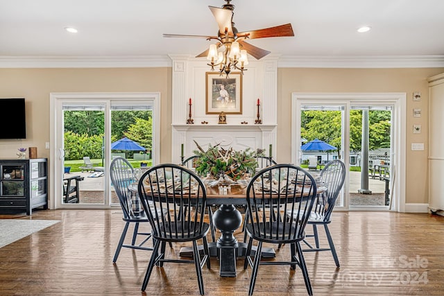 dining space featuring ceiling fan, light wood-type flooring, and ornamental molding