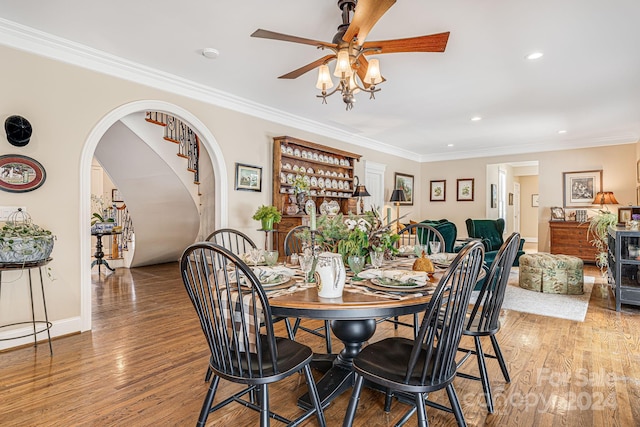 dining area with hardwood / wood-style floors, ornamental molding, and ceiling fan