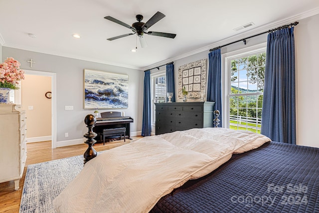 bedroom featuring ceiling fan, crown molding, and light hardwood / wood-style floors