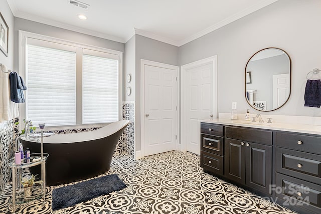 bathroom with vanity, crown molding, a tub to relax in, and tile patterned flooring