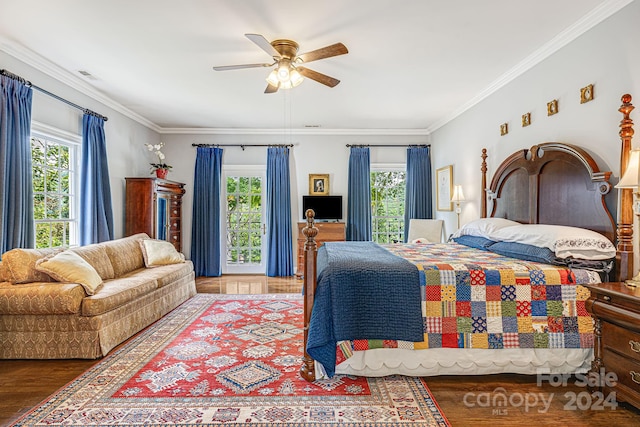 bedroom with ceiling fan, wood-type flooring, multiple windows, and ornamental molding