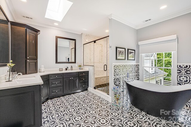 bathroom with crown molding, a skylight, tile patterned floors, walk in shower, and dual vanity