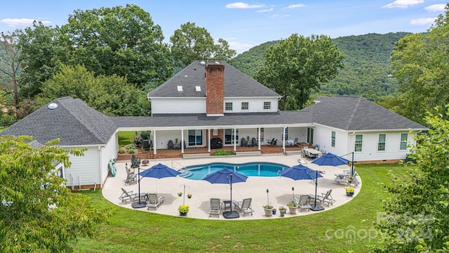 view of swimming pool with a lawn and a patio area