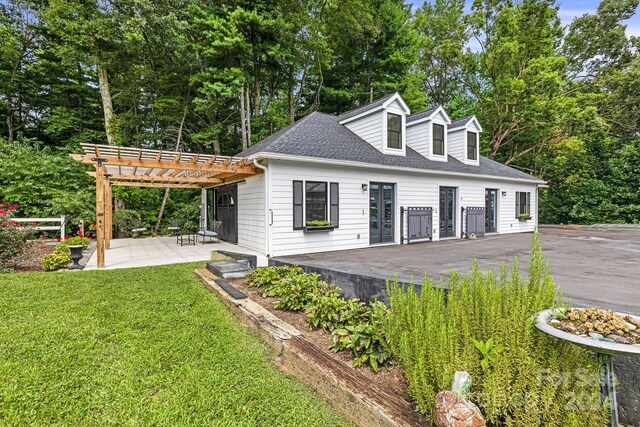 exterior space with a patio area, a pergola, and a front yard