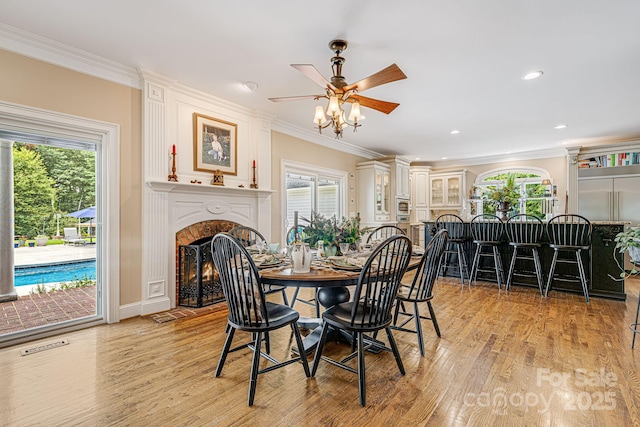 56 Fair Oaks Est, Fletcher, NC 28732 - dining space featuring a premium fireplace, light wood-style flooring, ornamental molding, and ceiling fan
