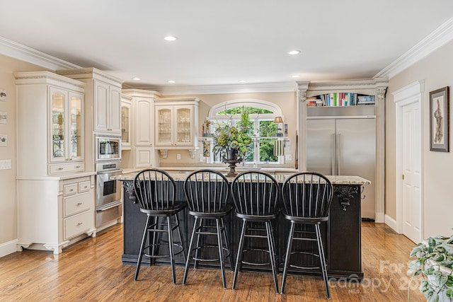 56 Fair Oaks Est, Fletcher, NC 28732 - kitchen with glass insert cabinets, a center island, a kitchen bar, and appliances with stainless steel finishes