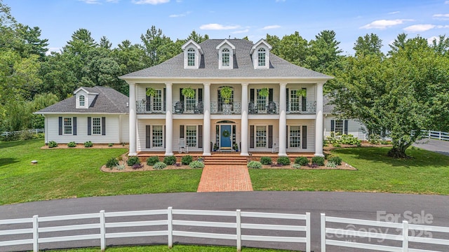 56 Fair Oaks Est, Fletcher, NC 28732 - neoclassical home with a shingled roof, a balcony, fence private yard, a porch, and a front yard
