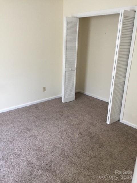 unfurnished bedroom featuring dark colored carpet