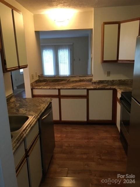 814 Selwyn Oaks Ct Unit 9/A & B, Charlotte, NC 28209 - kitchen with dishwasher, white cabinetry, dark wood-type flooring, and stove