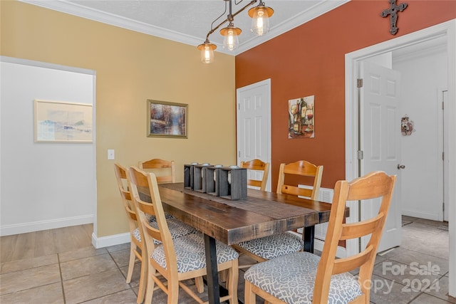 dining room featuring light tile patterned flooring and ornamental molding