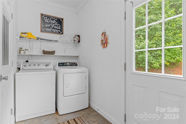 clothes washing area featuring washing machine and clothes dryer, ornamental molding, and light tile patterned floors