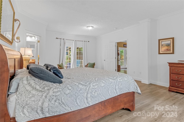 bedroom with ornamental molding and light hardwood / wood-style floors