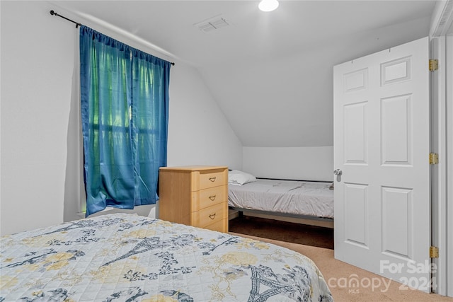 carpeted bedroom featuring lofted ceiling