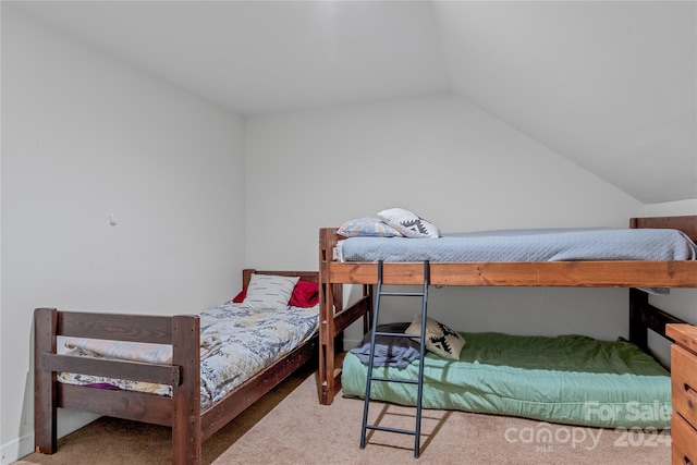 carpeted bedroom with vaulted ceiling