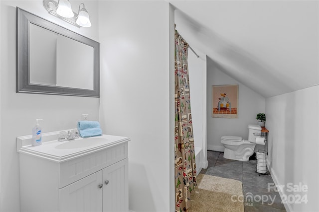 bathroom featuring tile patterned floors, vanity, vaulted ceiling, and toilet