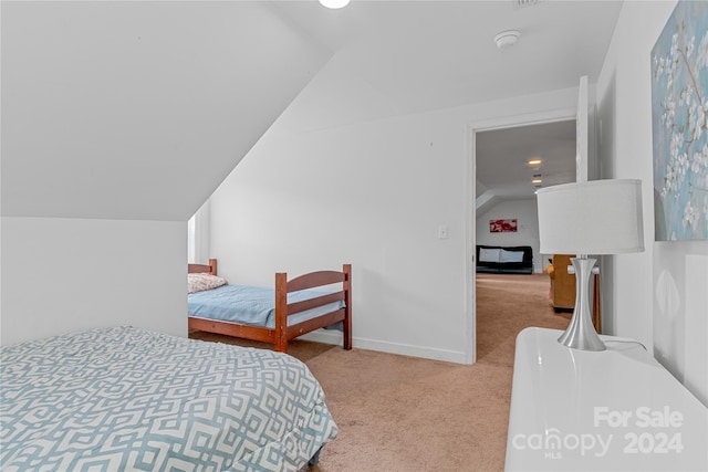 carpeted bedroom with vaulted ceiling