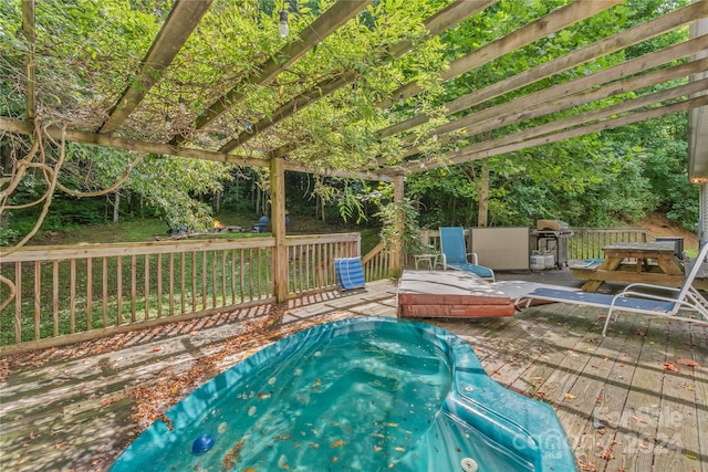 view of swimming pool with a jacuzzi and a deck