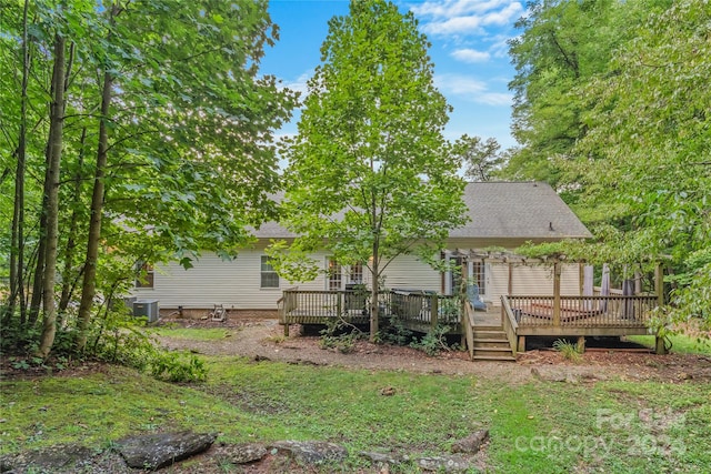 view of yard featuring a wooden deck and central AC unit