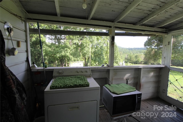 sunroom with washer / clothes dryer and wooden ceiling