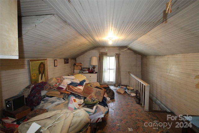 additional living space with wood walls, wood-type flooring, wooden ceiling, and vaulted ceiling