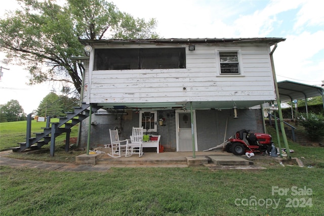 rear view of property featuring a yard