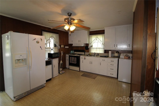 kitchen with washer / dryer, white appliances, white cabinetry, and ceiling fan