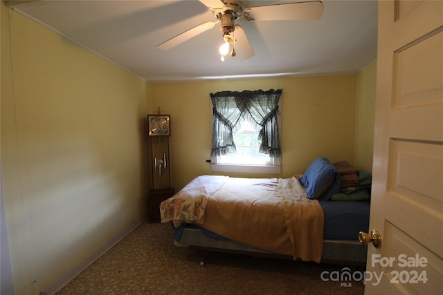 bedroom with crown molding, carpet, and ceiling fan