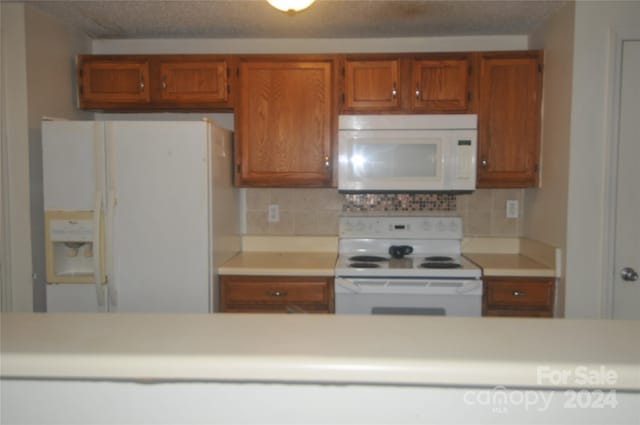 kitchen featuring white appliances and decorative backsplash