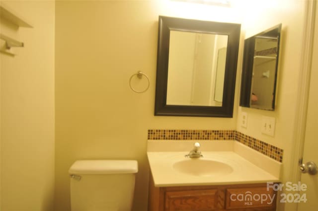 bathroom with toilet and vanity